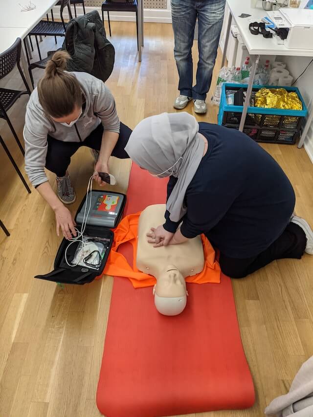 First aid student practising bandaging during a course
