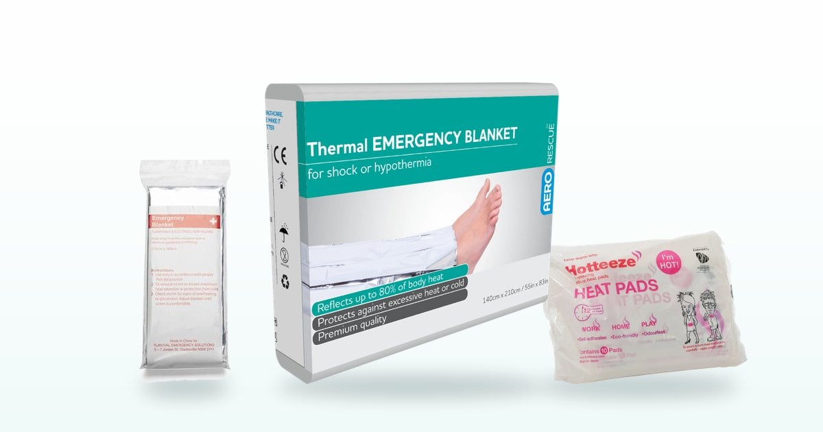Cold weather first aid: reflective emergency blanket, thermal blanket and heat patches